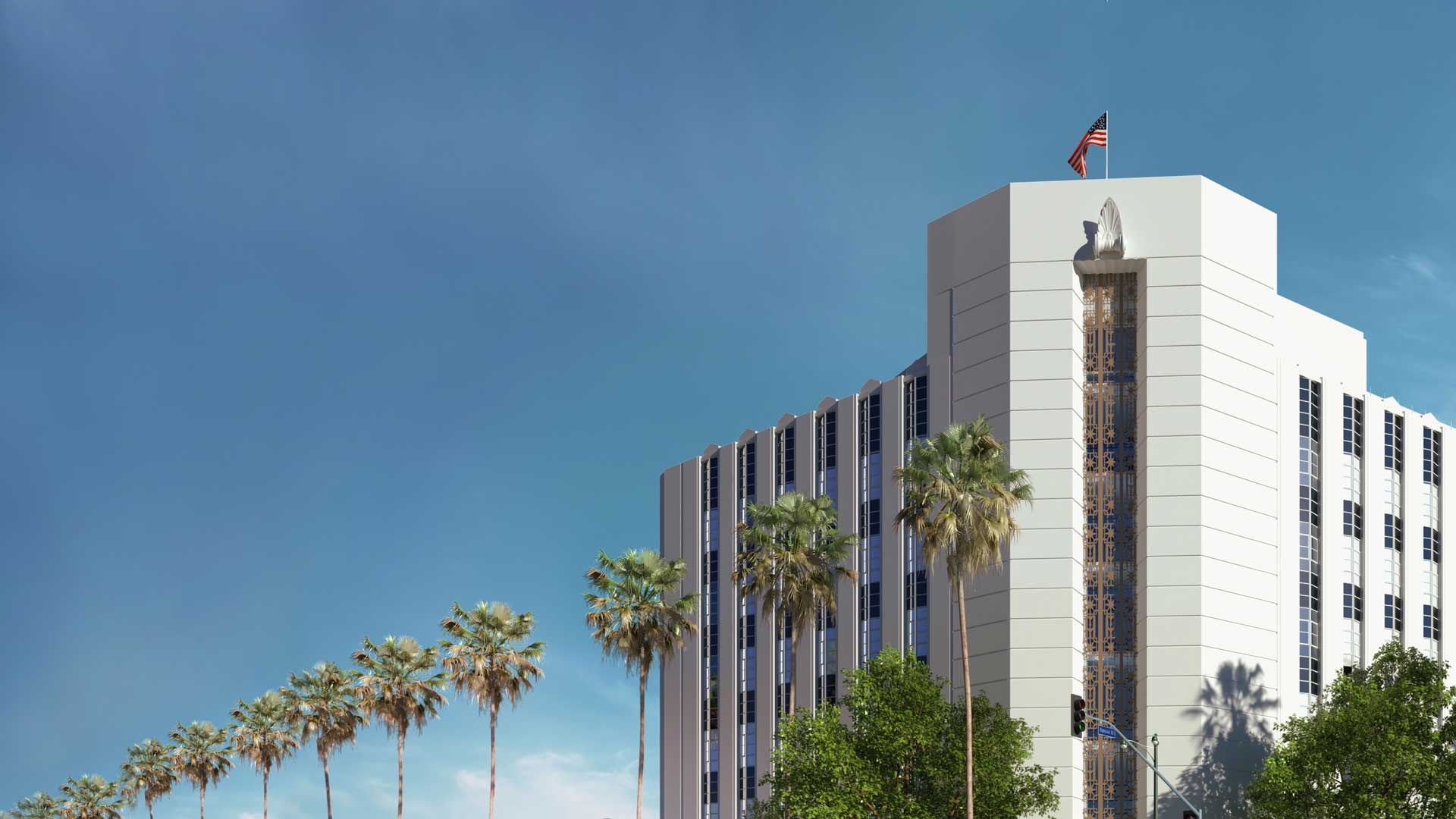 Front of Wilshire Mullen building with row of palm trees and blue sky